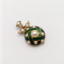 A pearl and green enamel pendant