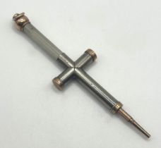 A novelty silver coloured and yellow coloured metal pencil, in the form of a cross