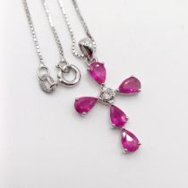 A 9ct white gold pear-shaped ruby and diamond cross on a silver chain, boxed, rubies 2.45ct approx.,