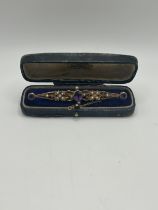 A late 19th/early 20th century, amethyst and seed pearl bar brooch, in a vintage jewellery box