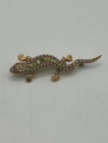 A 9ct gold and multi gemset lizzard bar brooch 6 cm length, One seed pearl missing, general wear