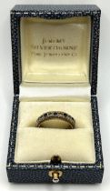 A white stone and sapphire eternity ring, ring size N, in a modern ring box