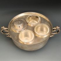 A George V silver hors d'oeuvres dish, London 1934, 14.9 ozt, with three clear glass liners, 17 cm