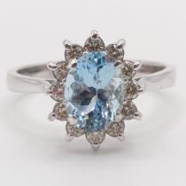 A 18ct white gold, oval aquamarine and RBC diamond cluster ring, aquamarine 0.80ct, diamonds 0.30ct