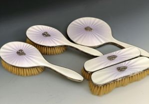A George V silver and enamel dressing table set, with applied silver foliate gemset motif,