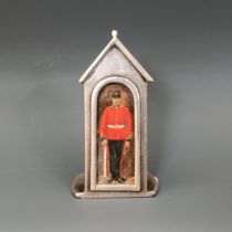 An Edward VII silver novelty menu holder, in the form of a sentry box, inset with a watercolour of a
