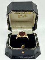 A 9ct gold and carved red stone Masonic signet ring, ring size U, in a modern jewellery box 4.6 g