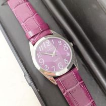 A plum coloured Gossip wristwatch, with quartz movement, functioning and boxed