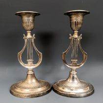 A pair of George V silver candlesticks, the stems in the form of harps, bases filled, Sheffield