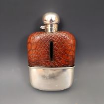 A George V silver glass and leather hip flask, Birmingham 1924 Surface scratches to cup, bayonet cap