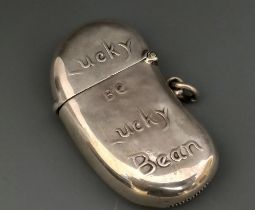 A late Victorian/Edwardian silver novelty vesta, in the form of a bean, with motto Lucky Bean,