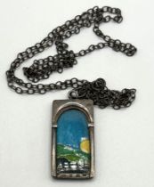 A 20th century silver and enamel pendant, on a chain overall condition good, no major faults