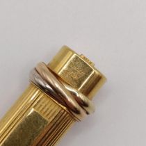 A Cartier Trinity ballpoint pen, in a gilt metal case, engraved a name
