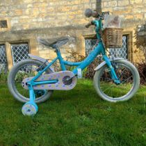 A girl's Raleigh Molli bicycle with stabilisers and basket, unused Part of new old stock from a