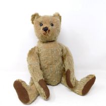 An early 20th century Steiff plush teddy bear, straw filled, with its button to the ear, 41 cm Re-