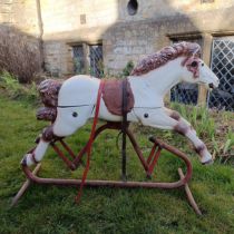 A vintage plastic rocking horse, on a metal frame, 79 cm wide