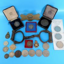 Assorted commemorative and other medallions, coins, a pair of iron handcuffs, and other items