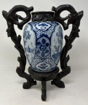 A blue and white Delft vase and cover, 30 cm high, and another with a Chinese style wooden mount (2)