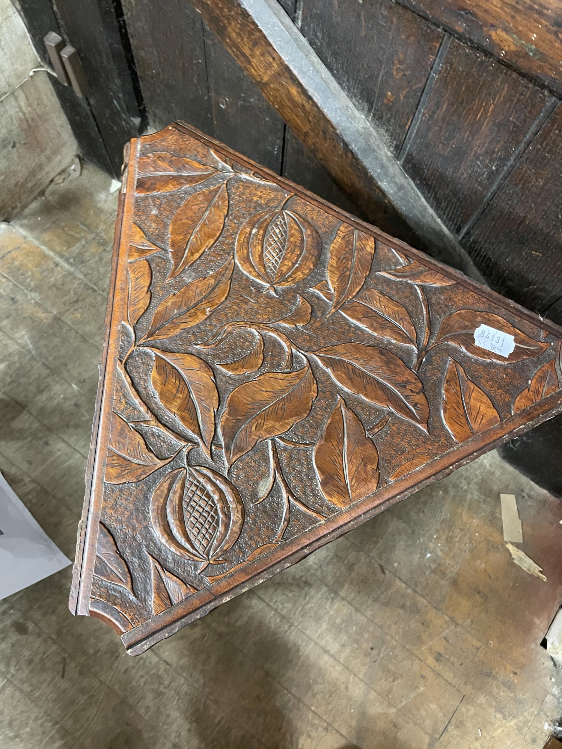 A carved walnut triangular table, with drop leaves, decorated leaves and pomegranates, 44 cm wide - Image 2 of 2