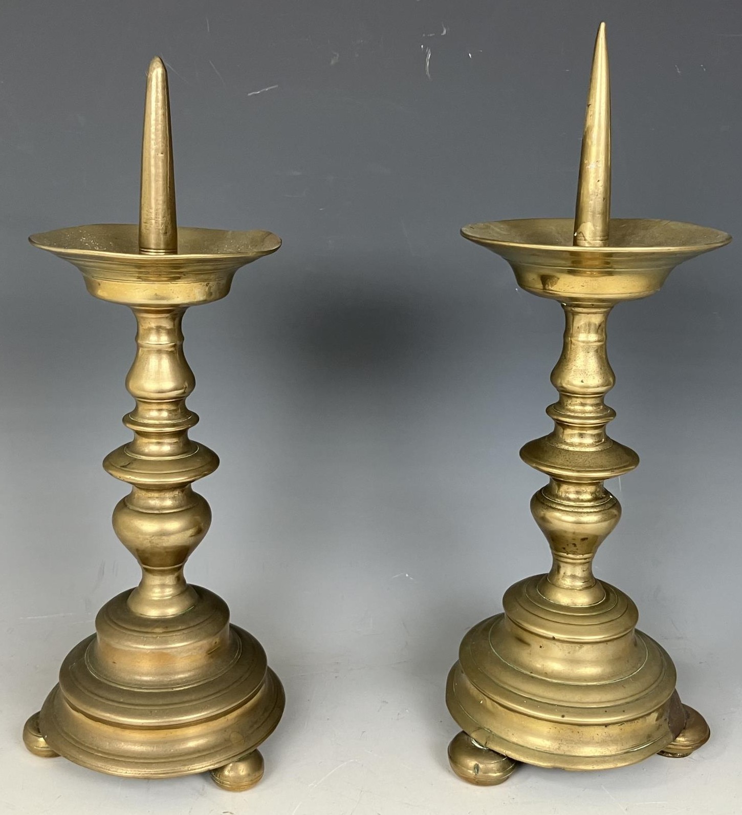A pair of brass picket candlesticks, 30 cm high