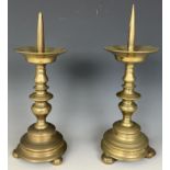 A pair of brass picket candlesticks, 30 cm high