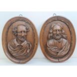 A pair of late 18th century carved oak oval panels, decorated bust portraits, 46 x 36 cm (2)