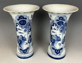 A pair of Delft blue and white vases, 23 cm high Rims repaired
