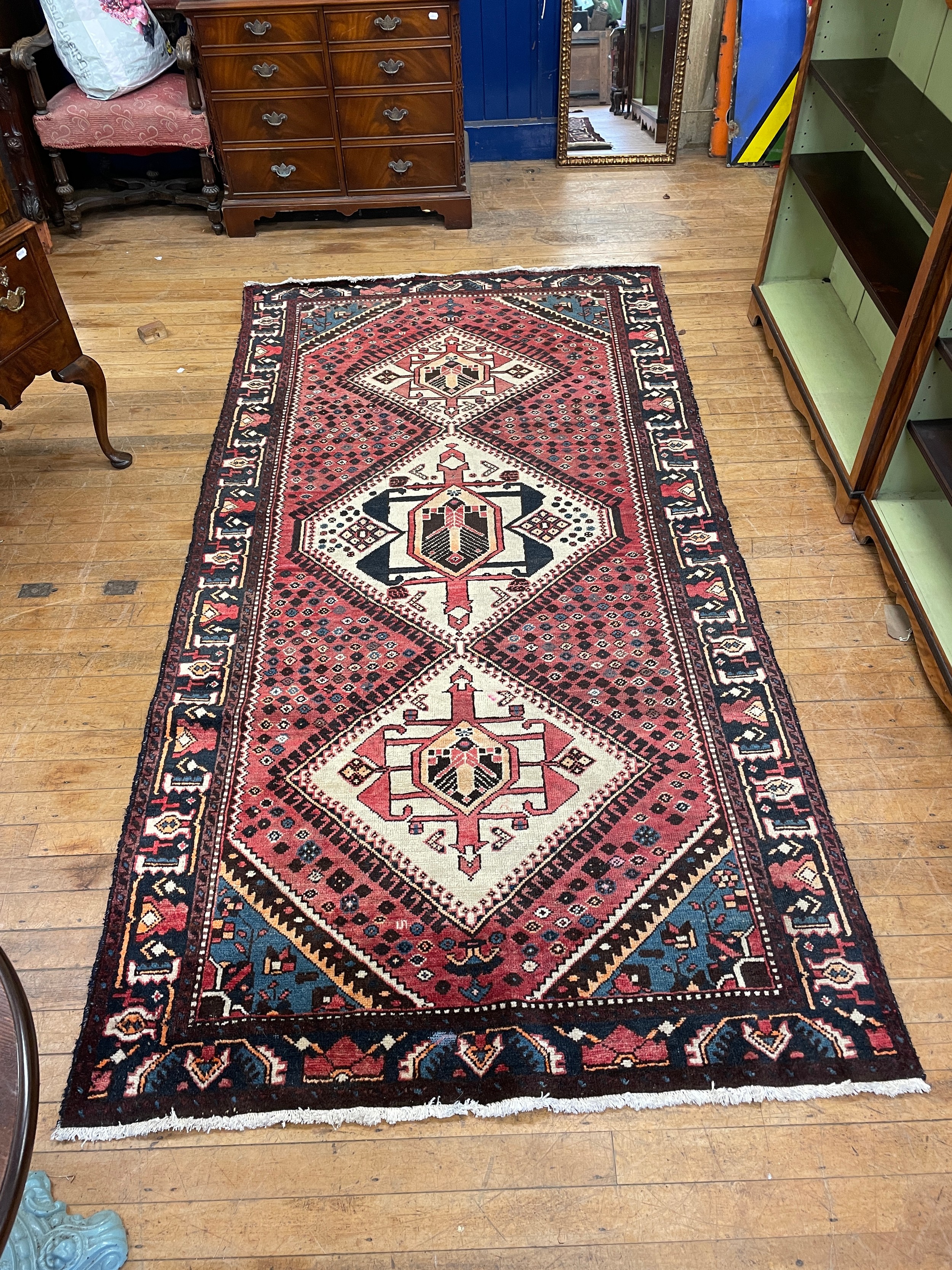 A Persian red ground carpet, 294 x 156 cm