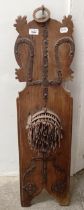 A wall mounted wooden plaque with metal spikes, 100 cm