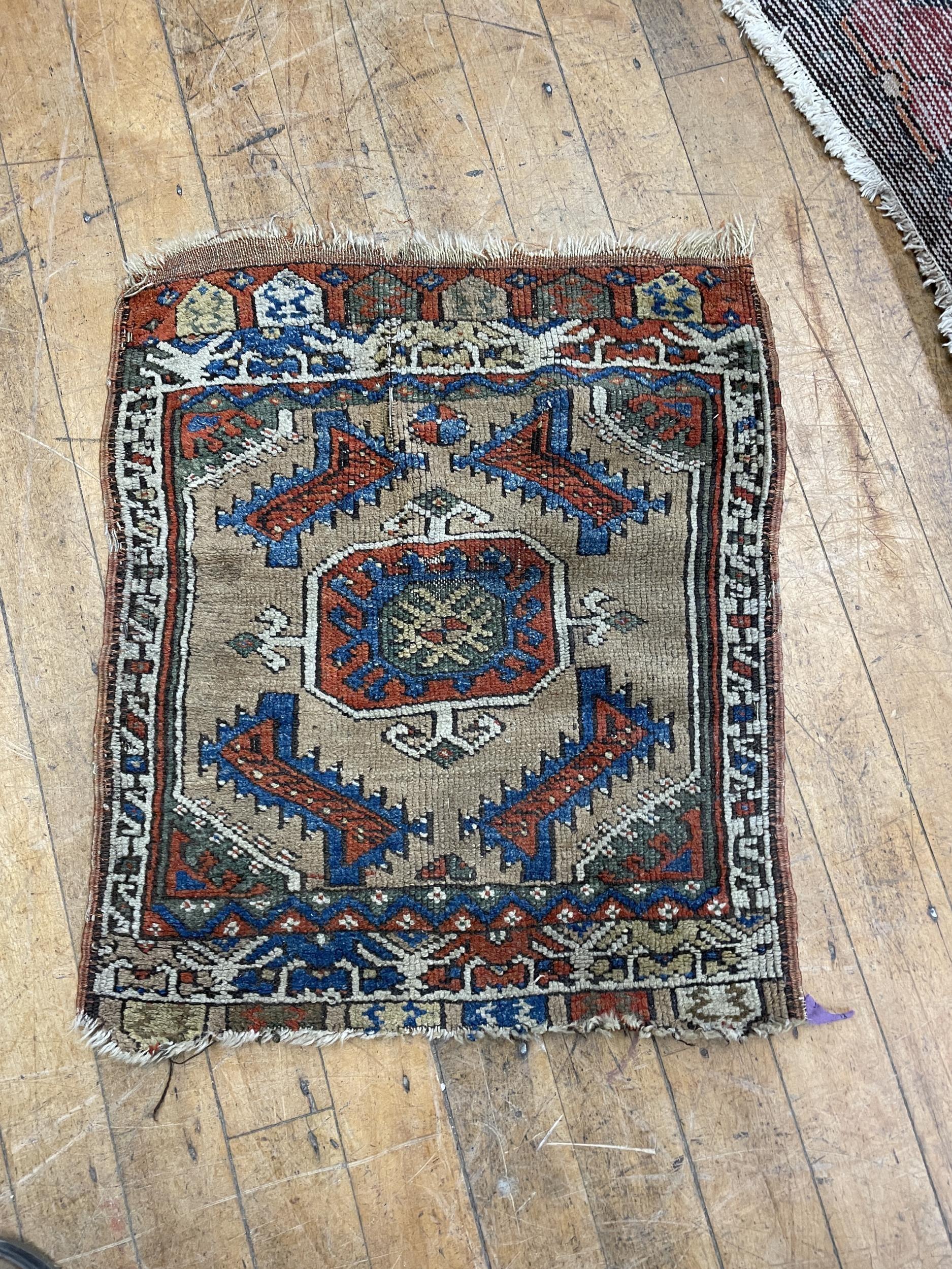 A Persian red ground rug, 284 x 79 cm, and a Persian rug, 64 x 54 cm