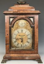 A bracket clock, the arched brass dial signed Isaac Nickals, Wells, the silvered chapter ring with