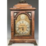 A bracket clock, the arched brass dial signed Isaac Nickals, Wells, the silvered chapter ring with