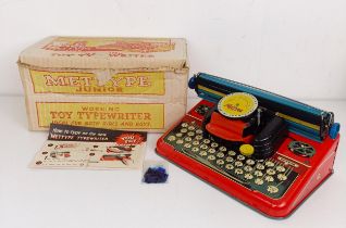 A Mettype Junior tinplate toy typewriter, boxed, a Pedigree Pretty Peepers doll, boxed, a Vulcan