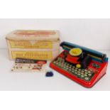 A Mettype Junior tinplate toy typewriter, boxed, a Pedigree Pretty Peepers doll, boxed, a Vulcan