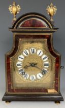 A mantel clock, with a gilt metal and enamel dial, striking on a bell, in a tortoiseshell ebonised