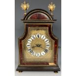 A mantel clock, with a gilt metal and enamel dial, striking on a bell, in a tortoiseshell ebonised