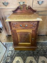 A walnut bedside cabinet, having a single drawer and a cupboard door, 45 cm wide
