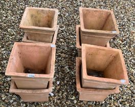 A set of eight square terracotta garden planters, 30 cm wide