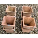 A set of eight square terracotta garden planters, 30 cm wide