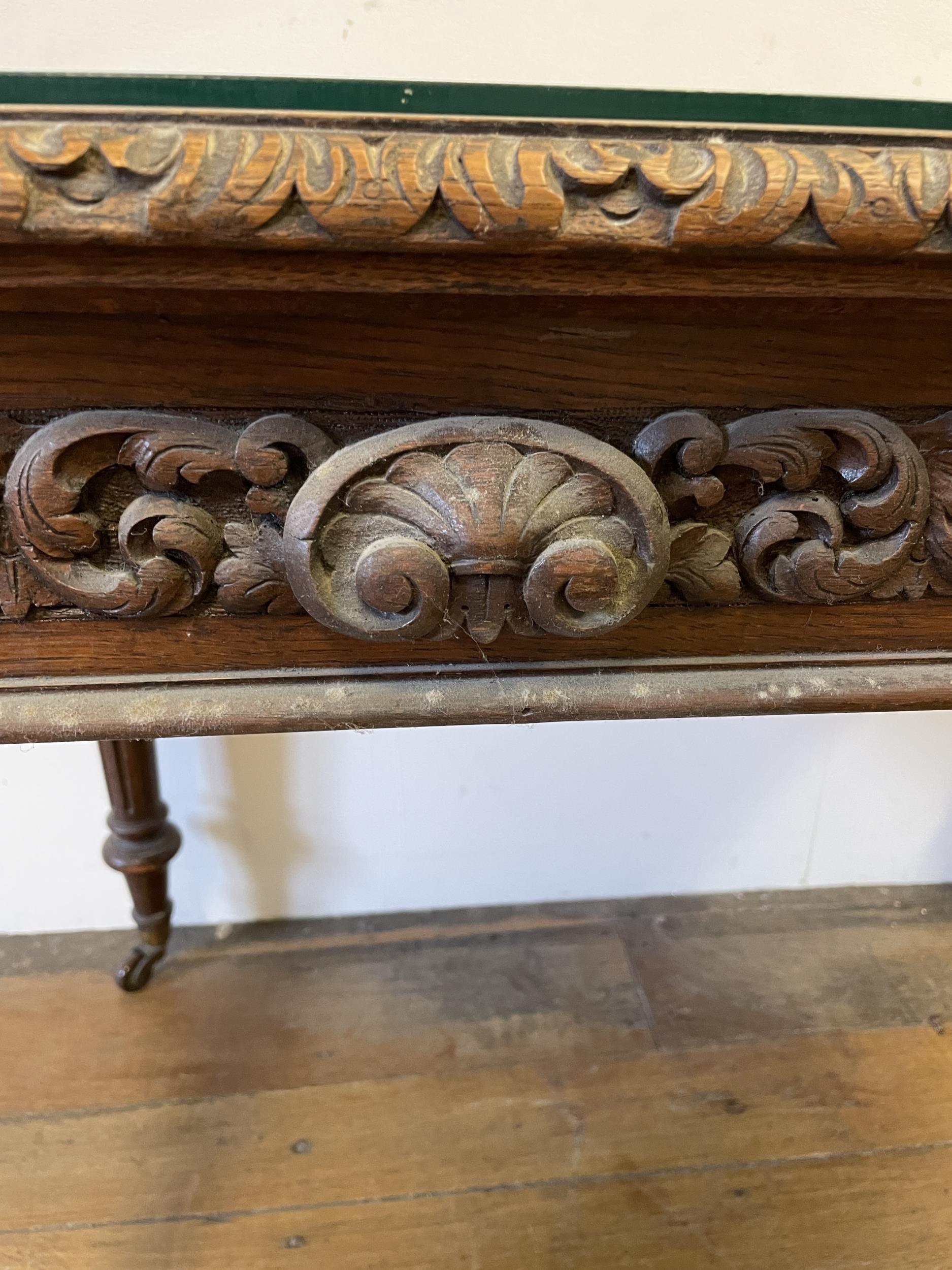 An oak writing desk, with a tooled and gilt leather top, having two drawers, on carved turned and - Image 2 of 4