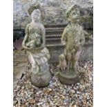 A pair of composite stone garden statues of a young boy and girl, 70 cm high