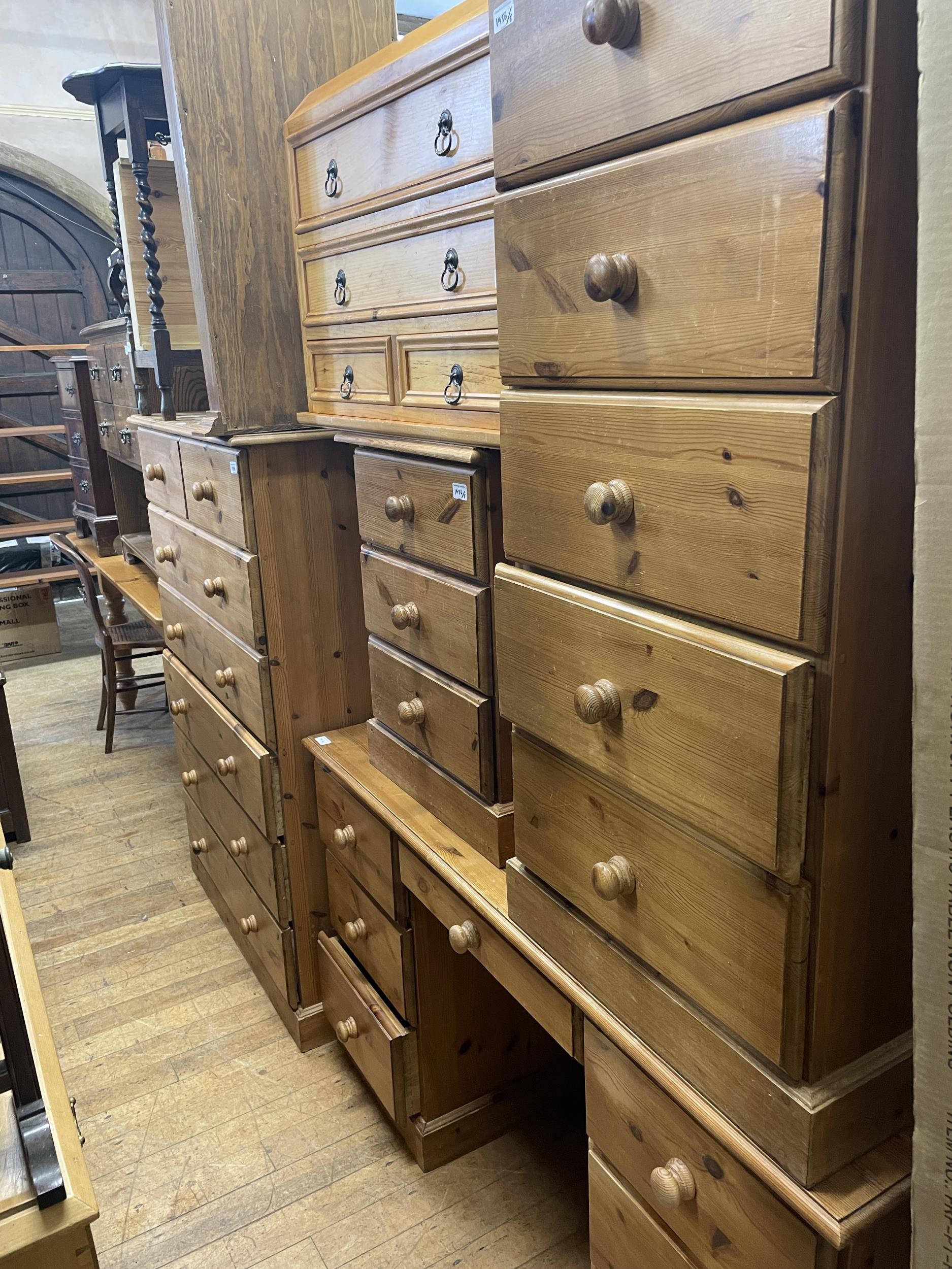 A pine chest, of two short and five long drawers, 92 cm wide, a dressing table, two pine chests
