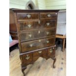 A walnut tallboy, the top having two short and three long drawers, the base with three drawers, on