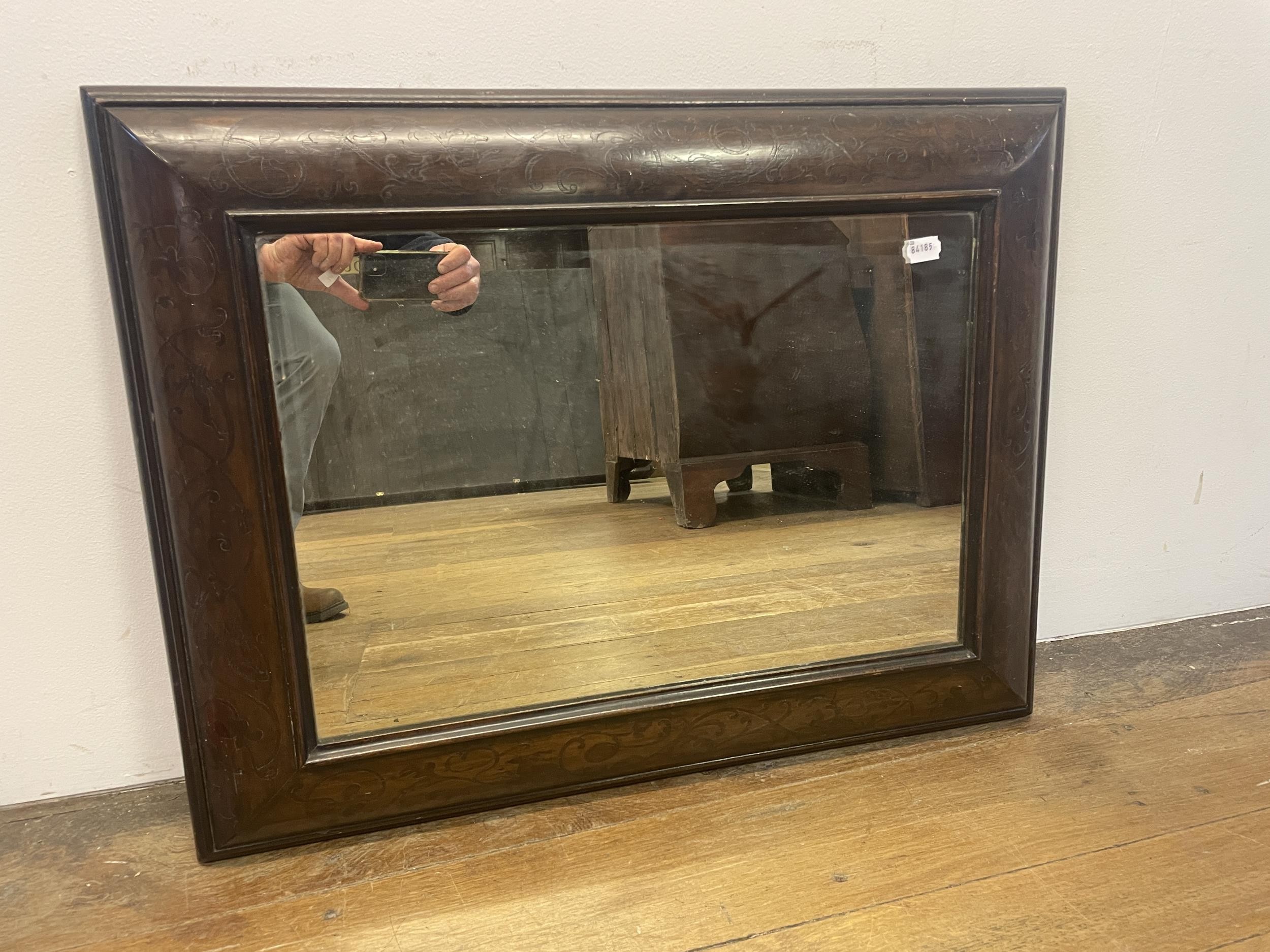 A mahogany cushion shaped wall mirror, 63 x 78 cm