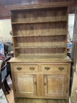 A pine dresser, the base with two drawers and two cupboard doors, 137 cm wide