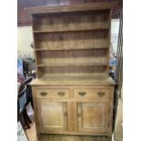A pine dresser, the base with two drawers and two cupboard doors, 137 cm wide