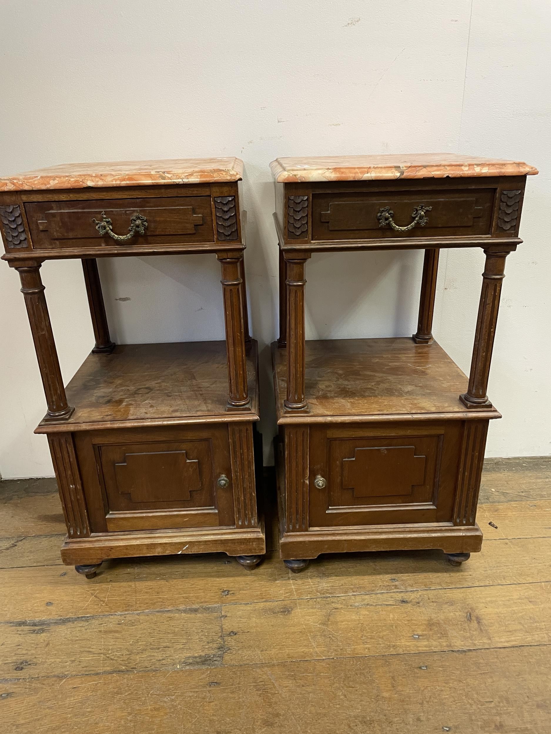 A pair of French walnut bedside tables, with marble tops, 40 cm wide