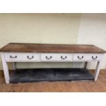 A Country house painted and stripped pine dresser base, having three drawers, 250 cm wide