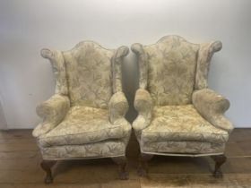 A pair of Georgian style wingback armchairs