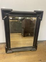 An ebonised wall mirror, 19 x 75 cm